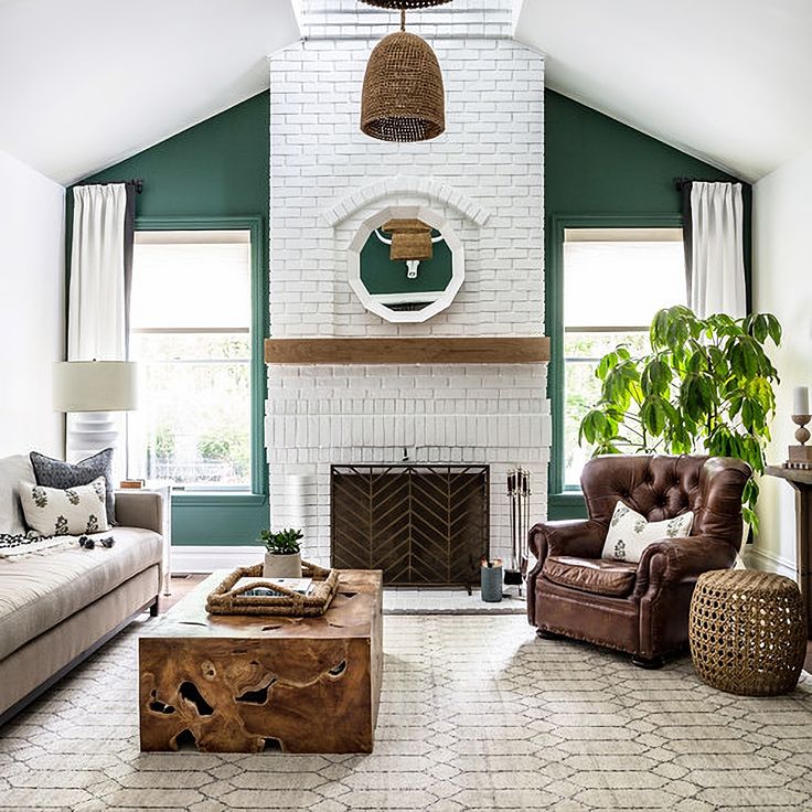 a living room filled with furniture and a fire place in the middle of a room