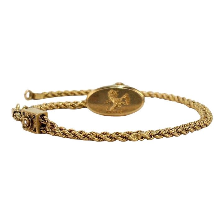 A very fine Victorian 14k gold and enamel watch chain with slides and a fob seal.  Comprised of a 14k gold rope chain with a decorative enameled gold slide and caps.  A seal is attached with a jump ring to the end of the chain and bears an engraved rampant lion with a fleur-de-lys shield.  Simply a fine piece!  Date: 19th Century  Overall Condition: It is in overall good, as-pictured used estate condition with some very light edge wear, some fine and light surface scratches here and there and ot Luxury Formal Rope Chain Jewelry, Antique Yellow Gold Jewelry With Adjustable Chain, Vintage Yellow Gold Jewelry With Gold Clasp, Victorian Yellow Gold Jewelry With Adjustable Chain, Formal Oval Link Rope Chain Jewelry, Elegant Gold Rope Chain Bracelet For Formal Occasions, Elegant Formal Gold Rope Chain Bracelet, Formal Yellow Gold Jewelry With Wheat Chain, Formal Yellow Gold Wheat Chain Jewelry