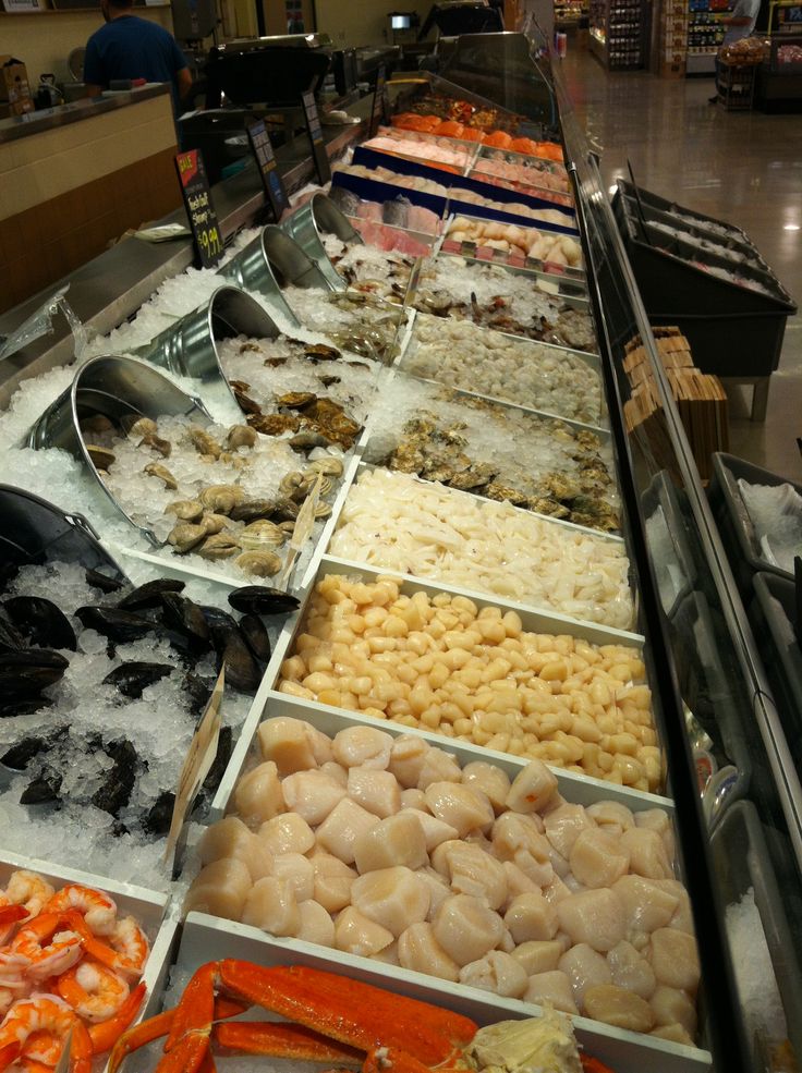 an assortment of seafood on display in a store