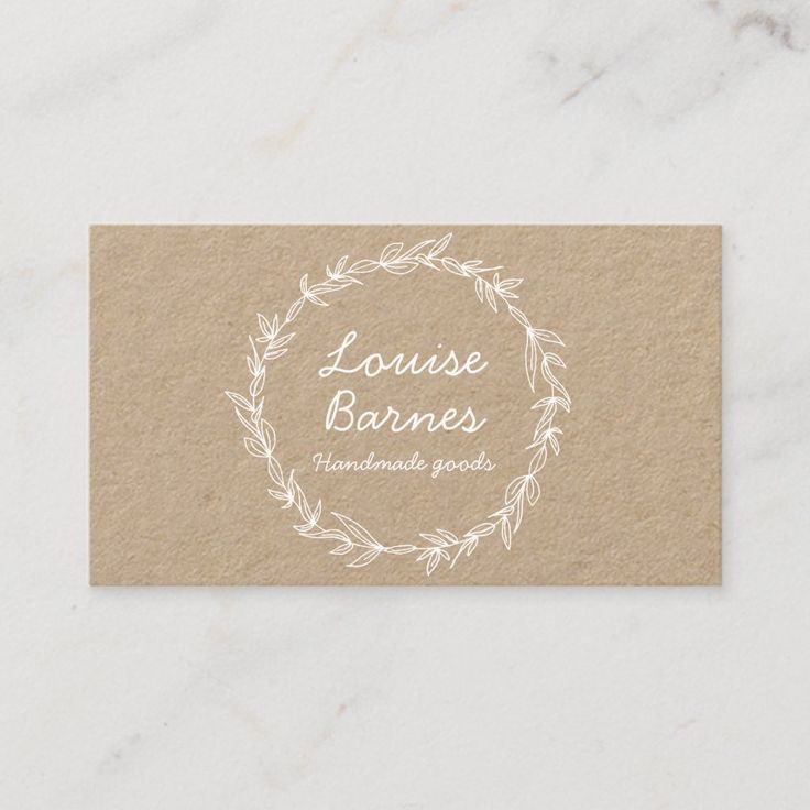 a business card with the words louise barnes on it and a wreath around it