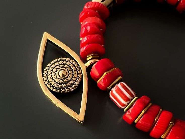 The Red Coral Evil Eye Bracelet displays a unique vibrant style and has immense spiritual and protective power. Featuring red coral stones and a large evil eye charm this bracelet is stylish and powerful to wear during meditation and daily life. The Evil Eye is a prominent symbol in Turkish and many other cultures, and is highly protective. Evil Eye is also called nazar. Evil Eye beads reflect ill intent and jealousy from the 'evil eye' back to the person thinking of it, hence protecting the wea Traditional Red Bracelets For Meditation, Red Spiritual Beaded Bracelets For Meditation, Handmade Red Symbolic Beaded Bracelets, Spiritual Red Coral Beads, Red Gemstone Beads Bracelets For Meditation, Red Coral Beaded Bracelets, Gemstone Beaded Bracelets For Festivals And Gifts, Red Beaded Bracelets With Natural Stones For Meditation, Red Jewelry With Colorful Beads For Meditation