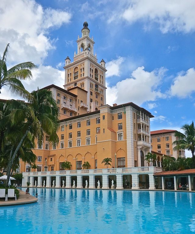 a large building with a pool in front of it