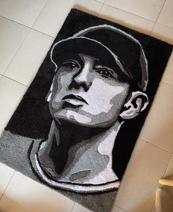 a bathroom rug with a drawing of a man in baseball cap on top of it