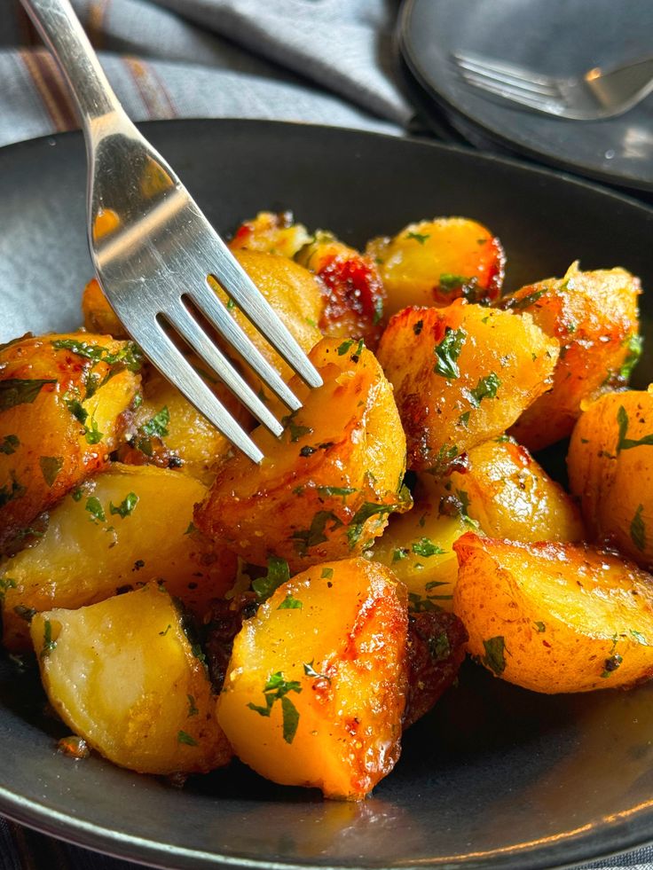 a fork in a bowl full of cooked potatoes