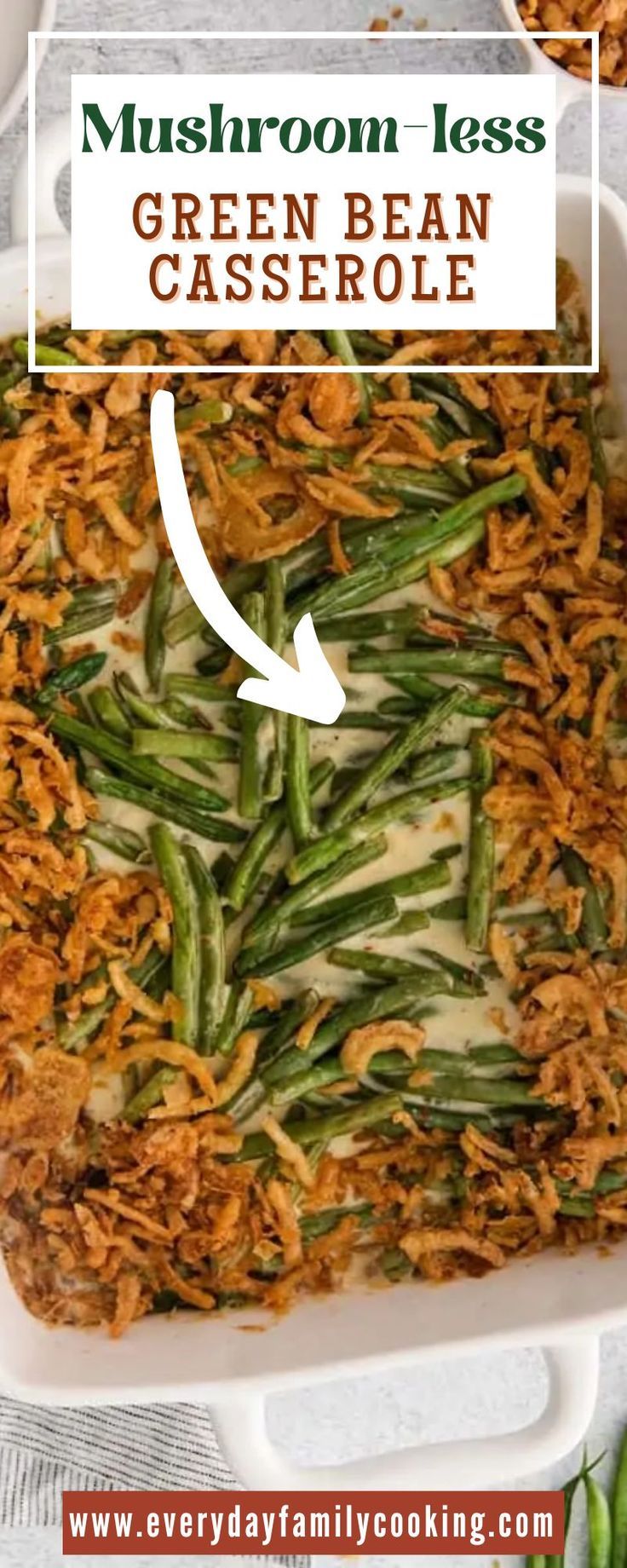 green bean casserole in a white dish with the words mushroom less on top