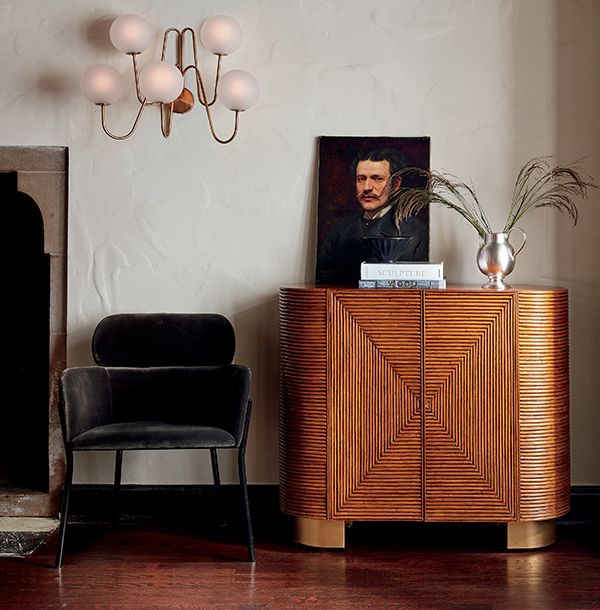 a living room with a chair and a painting on the wall