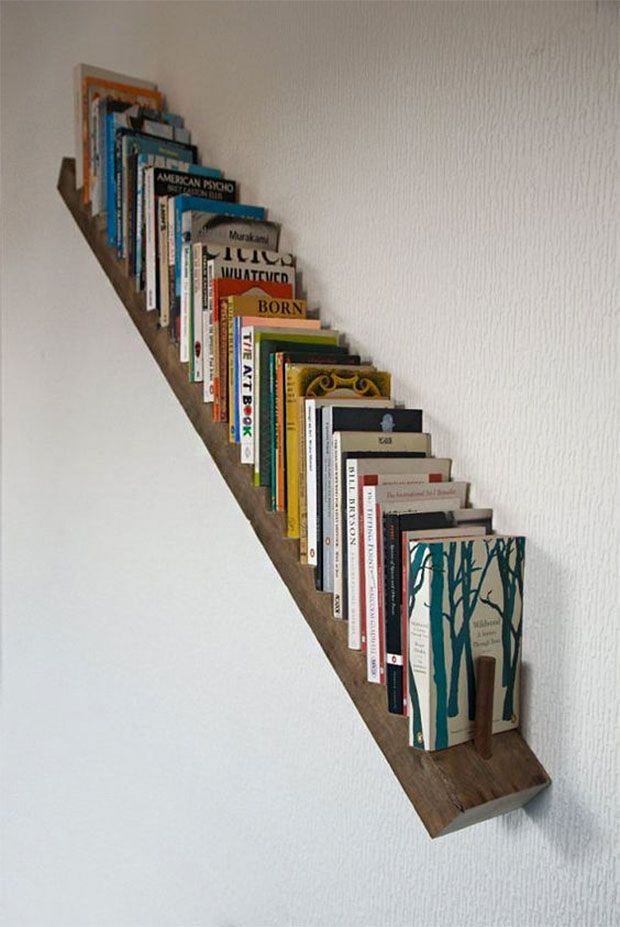 the books are lined up on the wall