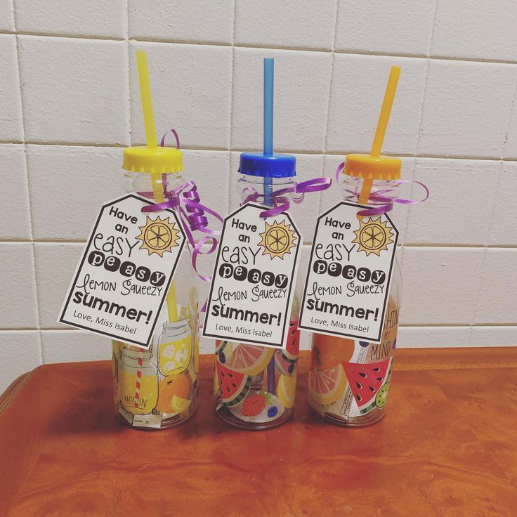 three jars with labels on them sitting on a table