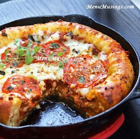 a deep dish pizza in a cast iron skillet