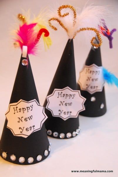 three party hats with happy new year written on them