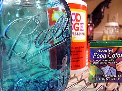 a blue mason jar sitting on top of a metal rack