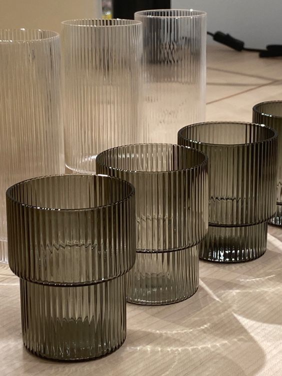 four glass cups sitting on top of a table