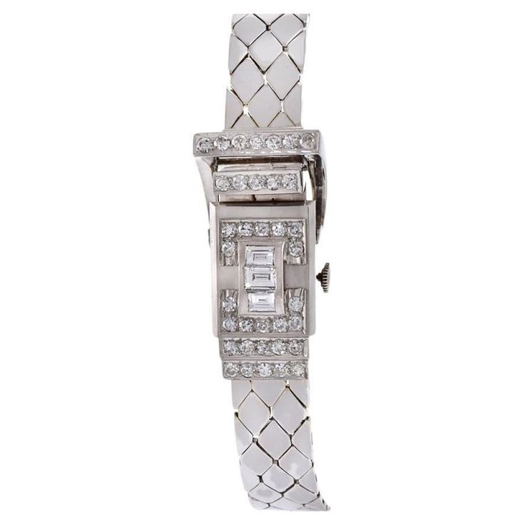 Introducing a masterpiece from Pesag, Vintage Retro Era design, the 14KT White Gold and Diamond Hinge Case Ladies Wrist Watch. This exquisite timepiece, featuring a 17x37mm case, exudes sophistication and glamour with its captivating design. Encased in 14KT White Gold, the hinge case is adorned with sparkling Diamonds totaling 2.75CT-TW, featuring a mix of F-VS-SI Emerald and Single Cut Rounds. The total weight of the watch is 48 grams. The Silver Dial, complemented by Roman Numeral markers, add Retro Era, Bracelets Gold Diamond, White Gold Bracelet, Women Wrist Watch, Roman Numerals, Sparkle Diamonds, Design Vintage, White Gold Diamonds, Vintage Charms