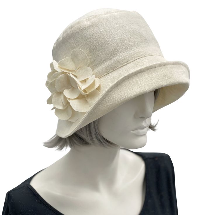 Eleanor Cream linen wide front brim cloche hat with hydrangea linen flower brooch  handmade Boston Millinery Fitted Cream Cloche Hat With Curved Brim, Adjustable Short Brim Hats For Garden Party, Chic Brimmed Cloche Hat For Garden Party, Chic Cloche Hat For Garden Party With Short Brim, Chic Cloche Hat With Short Brim For Garden Party, Adjustable Short Brim Cloche Hat For Garden Party, Vintage Fedora One Size Fits Most, Classic Spring Church Hat, Kentucky Derby Adjustable Cloche Hat With Flat Brim