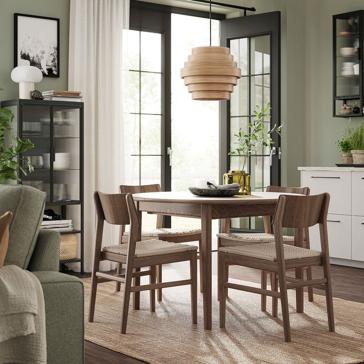 a dining room table with four chairs around it