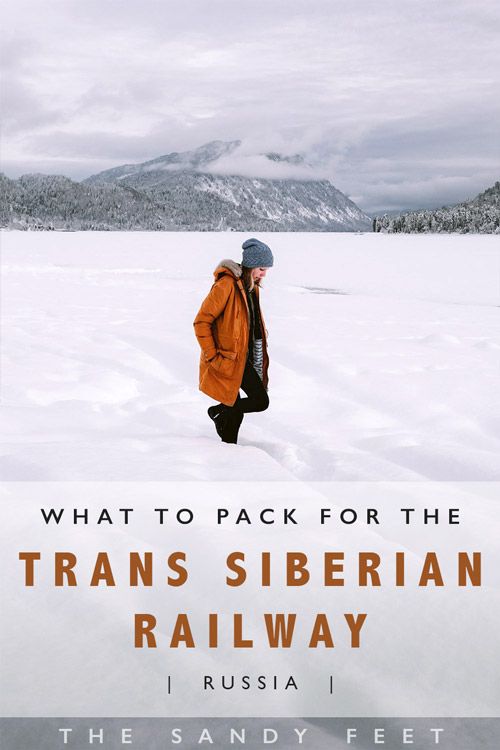 a man walking across snow covered ground with mountains in the background and text that reads, what to pack for the trans siberian railway