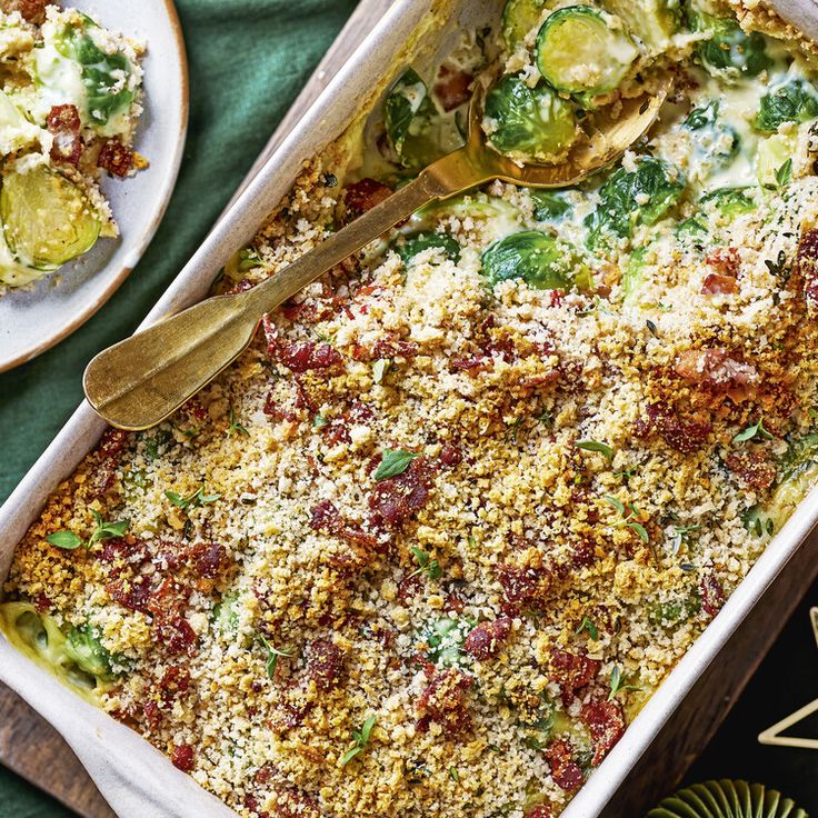 a casserole dish with broccoli, cheese and other toppings on it