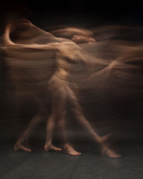 blurry image of two people dancing in the dark