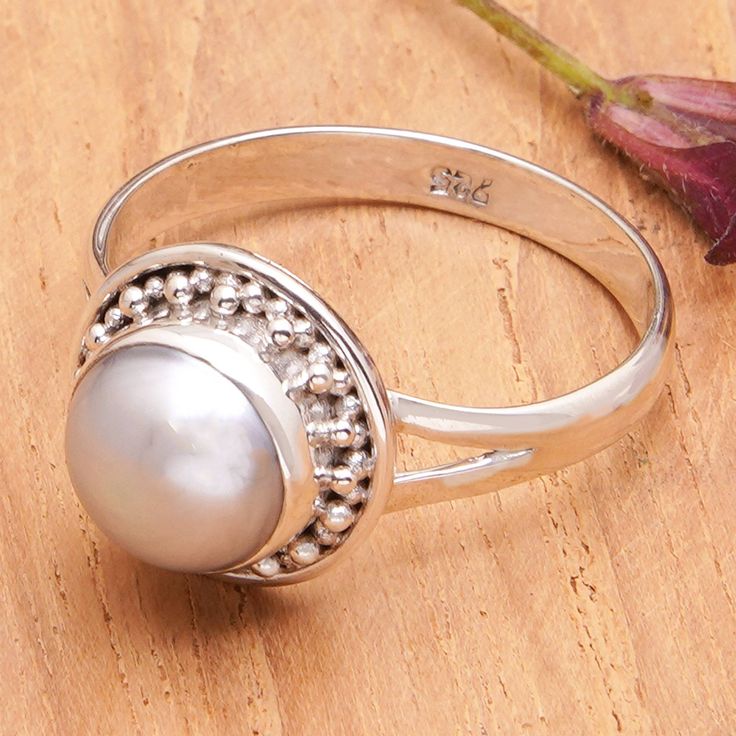 Bali's Ketut Sulastri crowns a superb design with a stunning grey cultured pearl set in sterling silver creation inspired by the sea. Being an expert in metalwork, the artisan crafts this cocktail ring in a combination finish, adding little metallic beads to the front, which creates the enchanting illusion of a myriad of pearls. Fine Jewelry Silver Pearl Ring With Polished Finish, Silver Pearl Ring With Polished Finish Fine Jewelry, Silver Pearl Ring With Polished Finish In Fine Jewelry, Elegant Sterling Silver Cabochon Pearl Ring, Classic Silver Pearl Ring With Polished Finish, Silver Sterling Silver Pearl Ring With Polished Finish, Cabochon Pearl Ring In Sterling Silver, Silver Rings With Pearl Drop In Fine Jewelry Style, Fine Jewelry Silver Pearl Ring