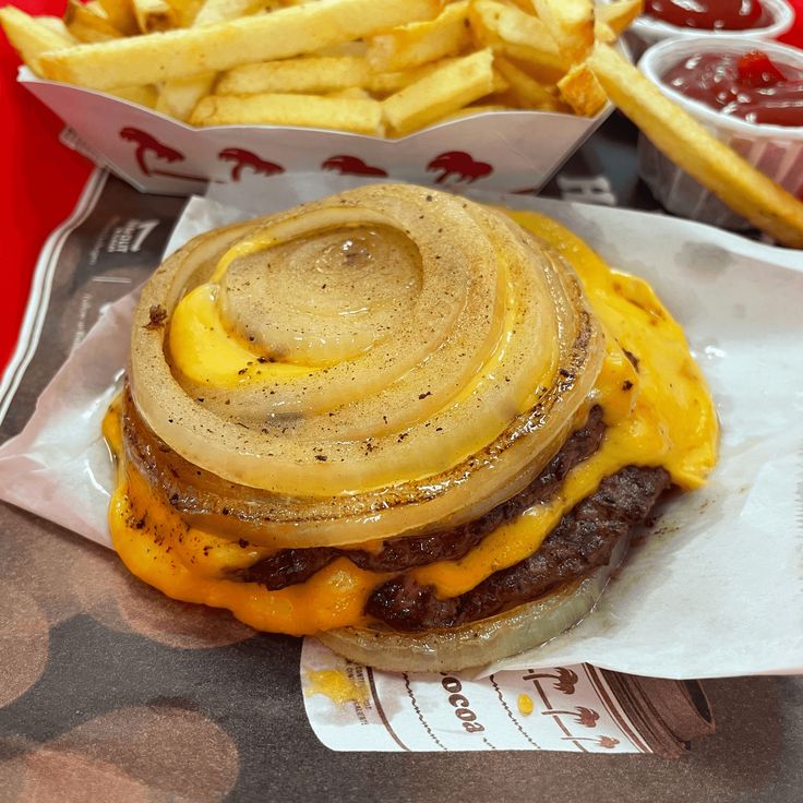 a cheeseburger with onion rings and fries on the side