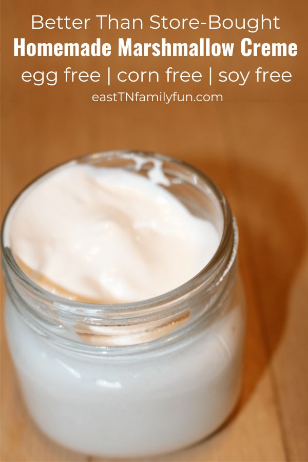 a jar of homemade marshmallow creme on a wooden table with text overlay that reads, better than store - bought homemade marshmallow creme egg free