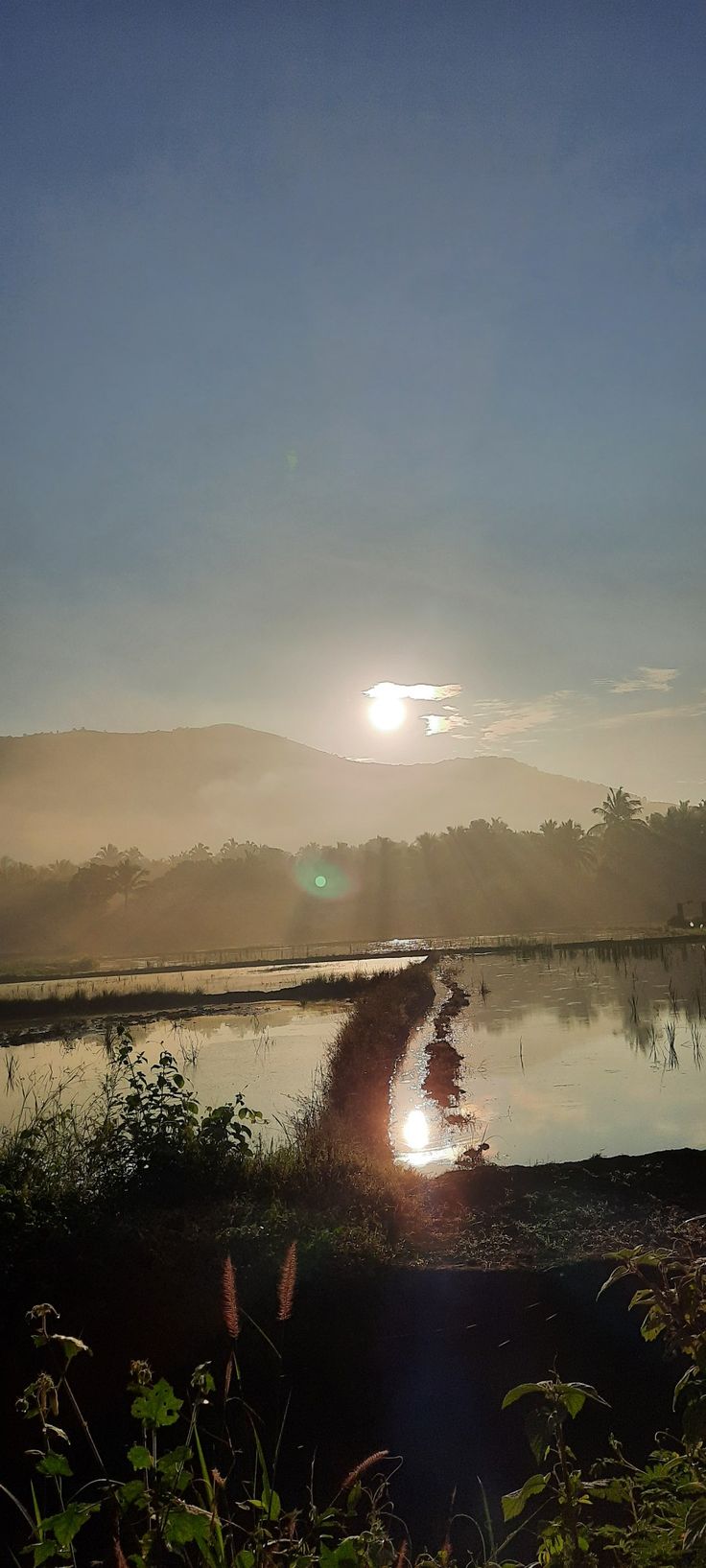 the sun is setting over a body of water