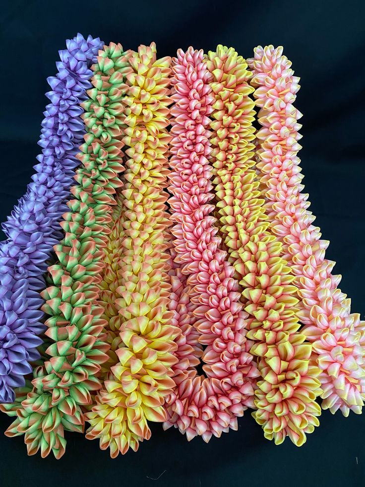 several different colored flowers on a black background