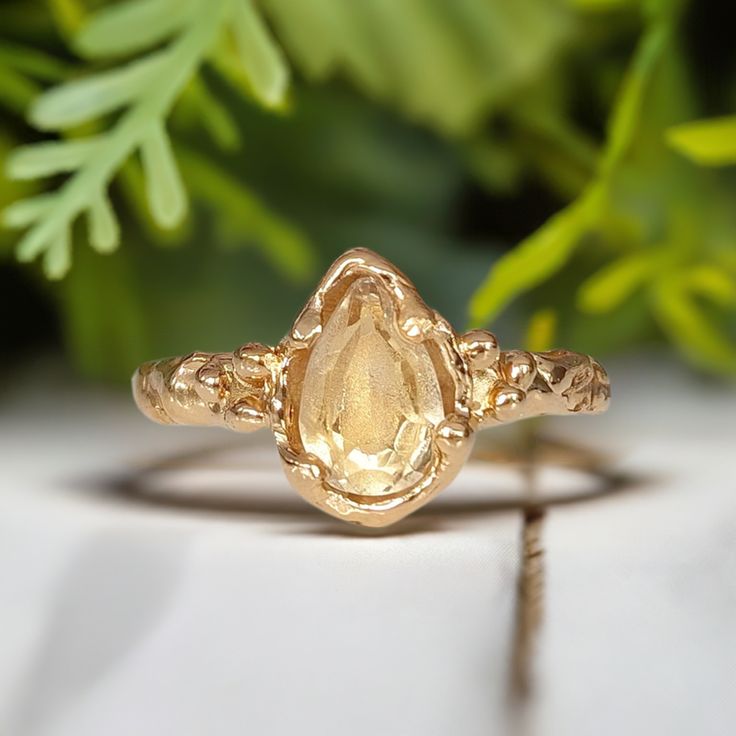 Show your love with this stunning Citrine ring - handcrafted in wax and cast in Solid 14k Gold, its organic molten band exudes natural charm. This one-of-a-kind engagement ring features a stunning pear shape yellow crystal as the November birthstone - in celebration of love's eternal bond.T H E ∙ S M A L L ∙ D E T A I L S• Pear shape faceted Citrine (8-10mm)• Solid 14k Gold textured bandM A T E R I A L ∙ O P T I O N S• Sterling Silver• Solid 14k GoldYou will receive a ring very similar to the on Citrine Engagement Ring, Citrine Ring Engagement, Wedding Types, Nature Inspired Rings, Engagement Rings Affordable, Topaz Engagement Ring, Citrine Ring, November Birthstone, Gold Texture