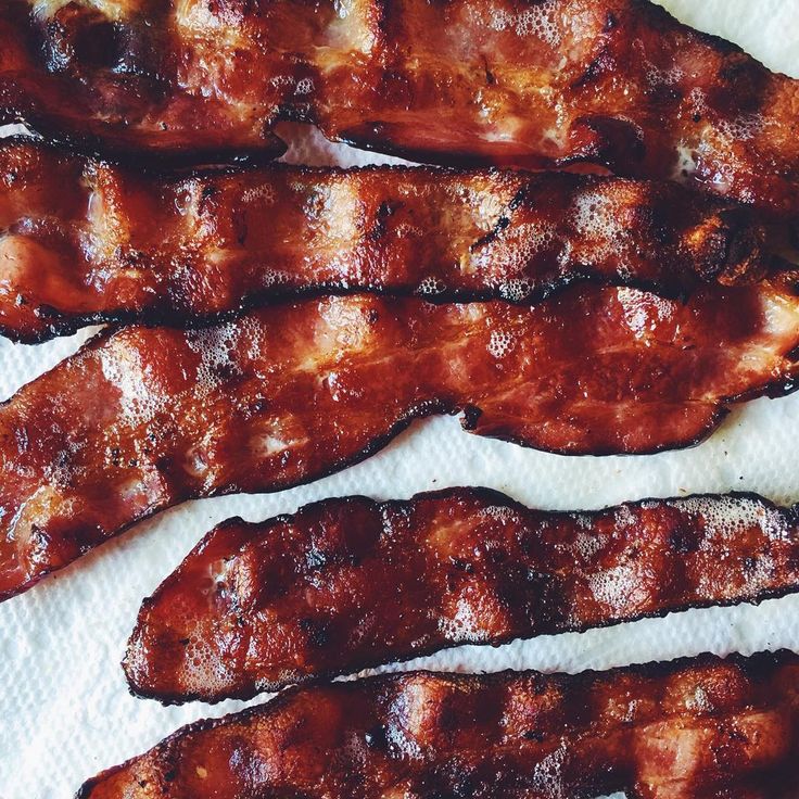 bacon strips sitting on top of a white paper towel