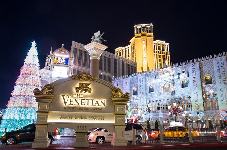 the venetian hotel and casino in las vegas is lit up at night with christmas lights