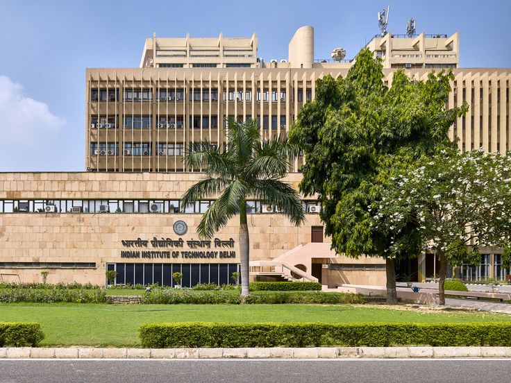 a large building with palm trees in front of it