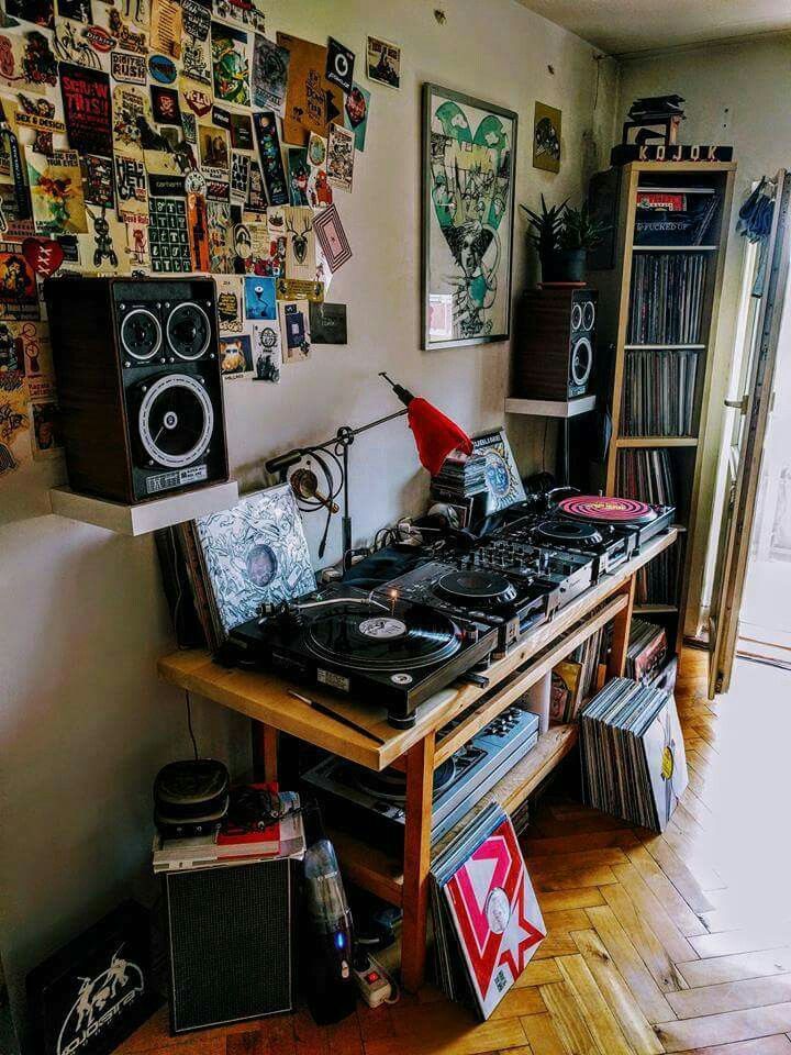 a record player sitting on top of a wooden table in a room filled with records