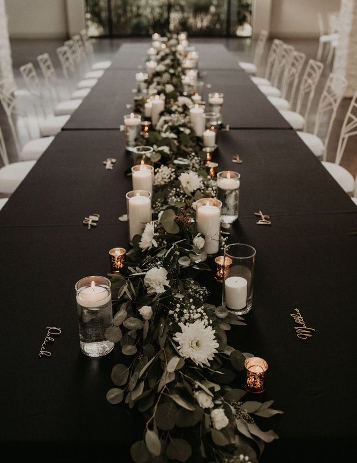 a long table with candles and flowers on it is set up for a formal function