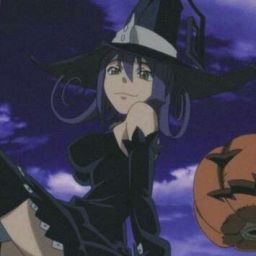 a woman in a witches costume with a pumpkin on the ground next to her head