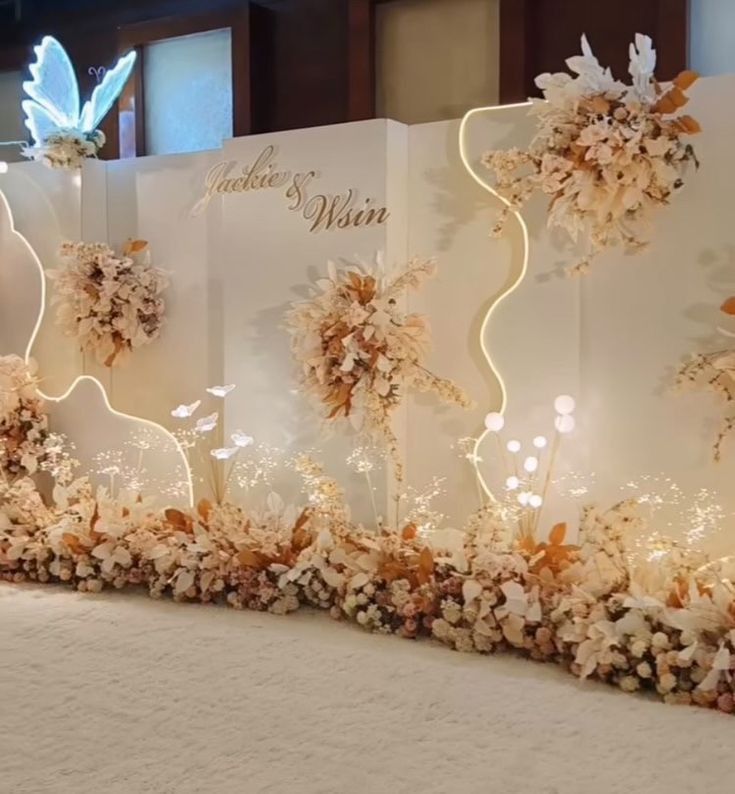 an elaborate display with flowers and butterflies on it