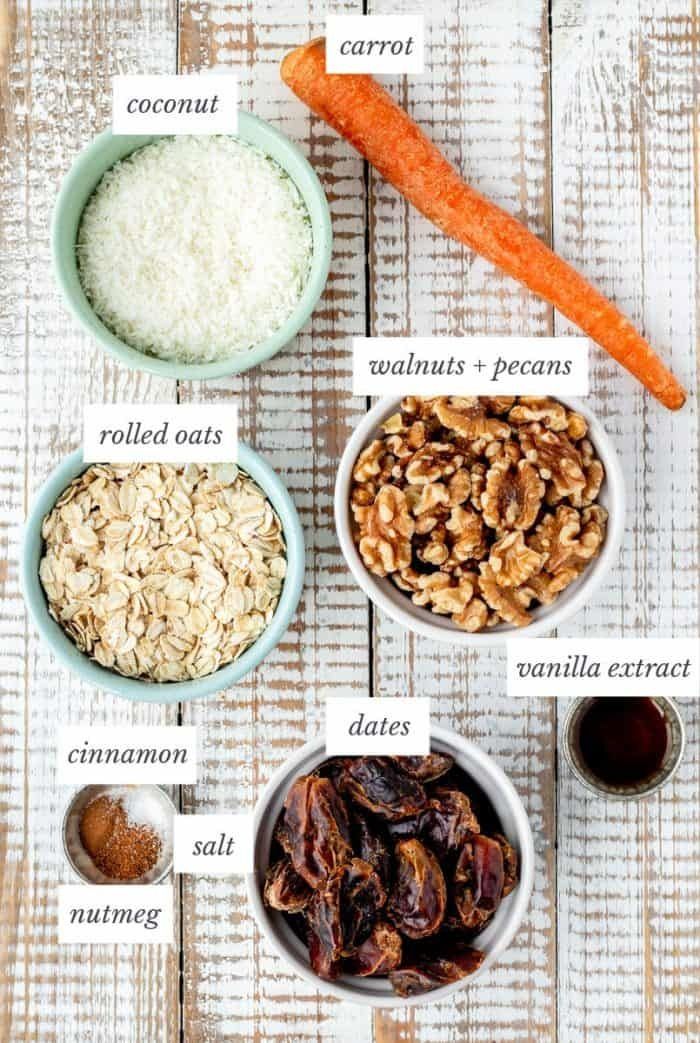 the ingredients to make carrot oatmeal in bowls on a white wooden table