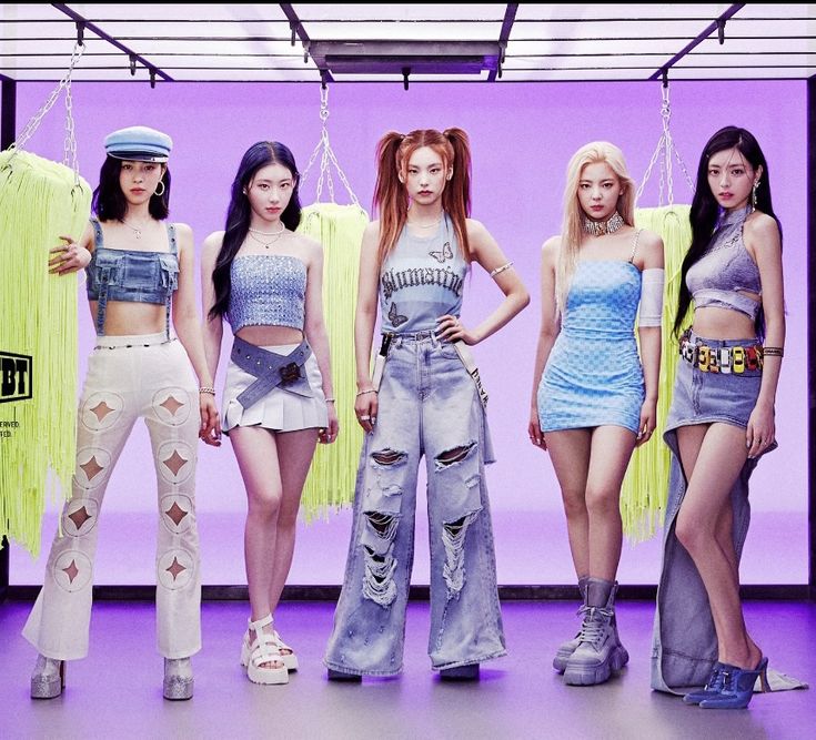 the girls are standing in front of a purple background