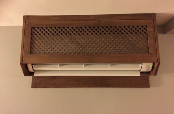 an air conditioner mounted to the side of a wall above a window sill