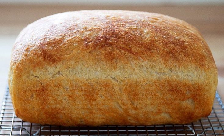 a loaf of bread sitting on top of a cooling rack