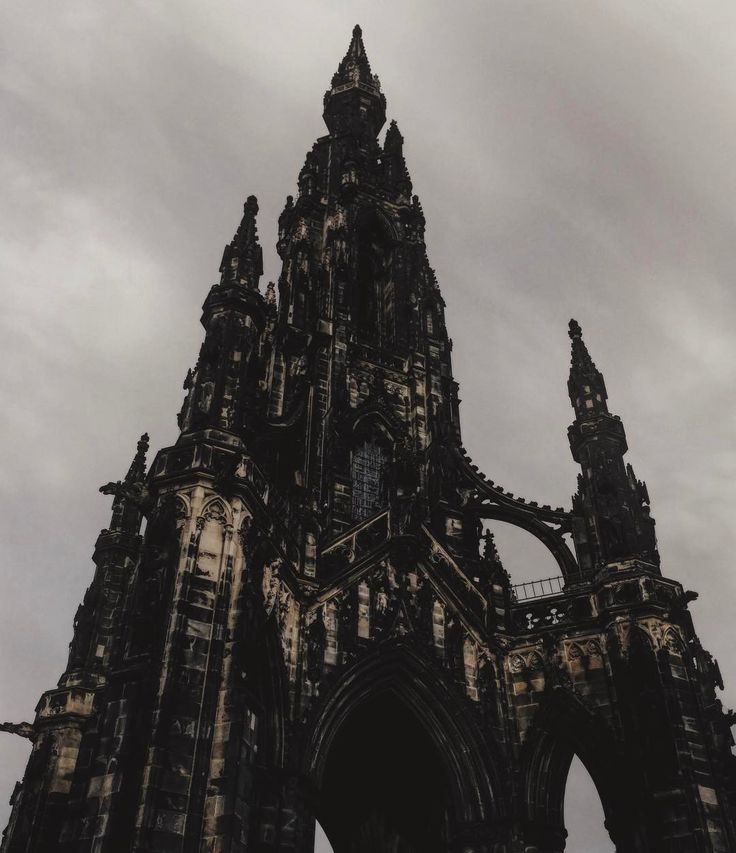 the silhouette of an old cathedral against a cloudy sky