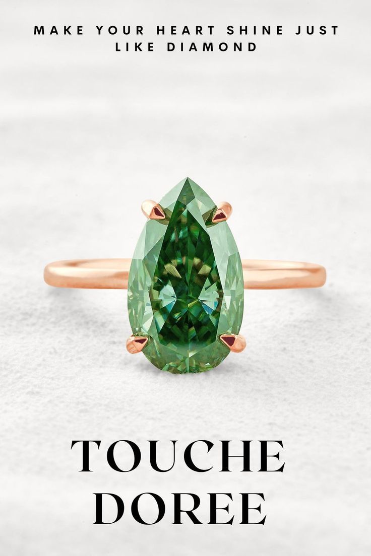 an oval cut green tourmaline gemstone ring in rose gold on a white background