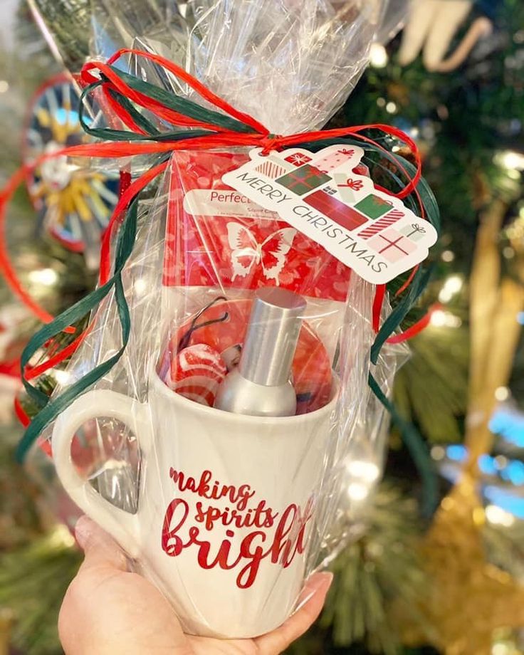 someone holding up a coffee mug with christmas decorations on it