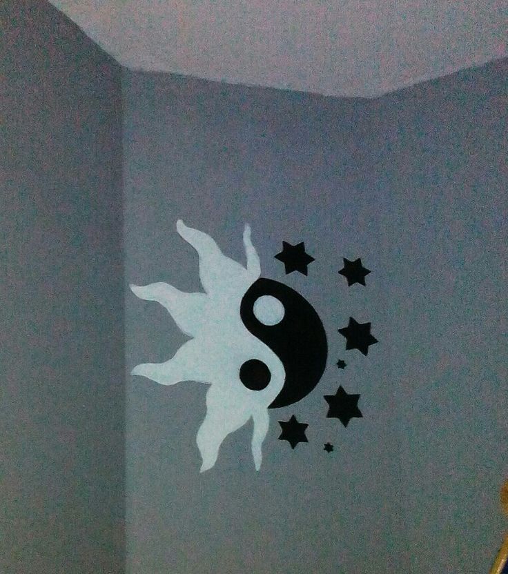 the wall is painted with black and white decals in a room that has stars on it