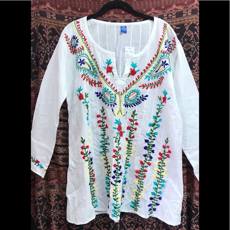 Cotton Long Sleeve White Folk Style V-neck Blouse, Casual White Peasant Top For Festival, Floral Embroidered Top For Fall Vacation, Fall Floral Embroidery Long Sleeve Tunic, Floral Embroidered Top For Vacation In Fall, Traditional White V-neck Embroidered Top, White Peasant Top For Festival, White Tunic Blouse For Festival, Summer Embroidered Long Sleeve Tunic