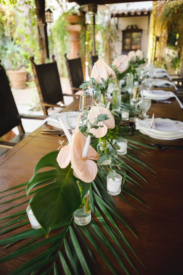 the table is set with flowers and greenery for an elegant dinner party or special event