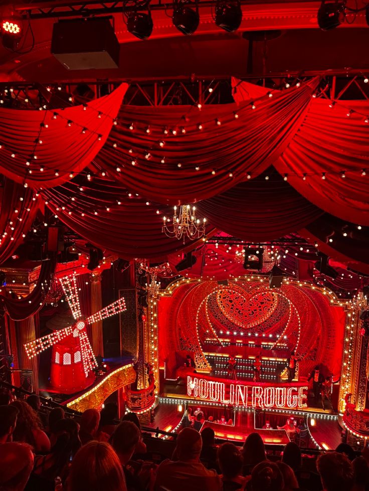 the stage is decorated with red lights and draping for valentine's day