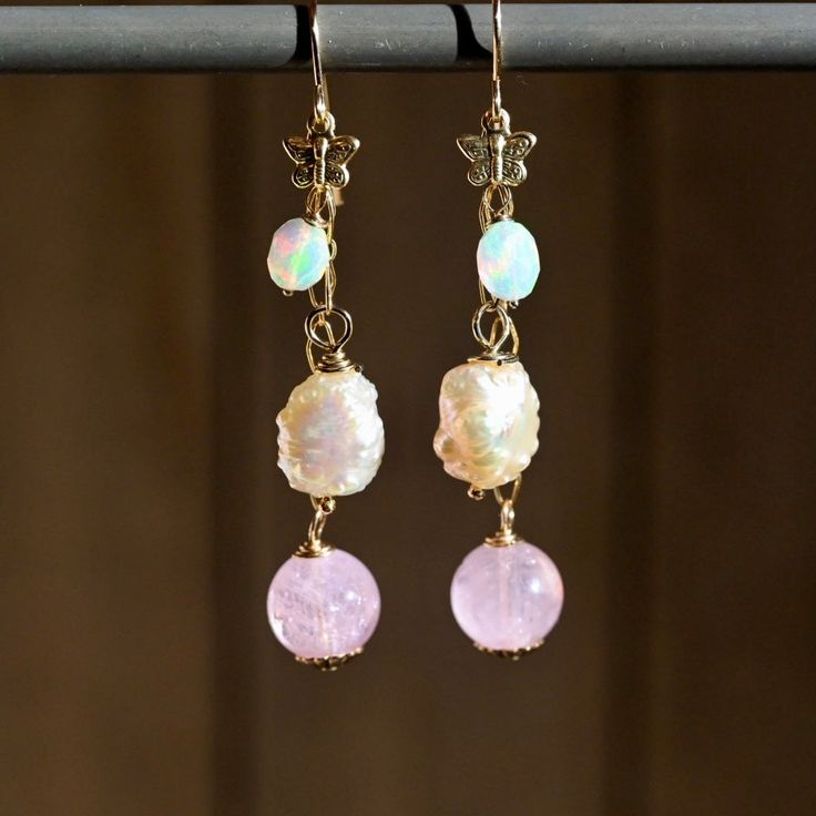 Experience the elegance and whimsy of our Butterfly Pink Dangle Earrings. Featuring soft, natural gemstones in stunning shades of pink and a luxurious 14K gold fill, these earrings make a bold statement. With a length of 2 1/2 inches, they effortlessly capture attention while also exuding a playful charm. A must-have staple for any wardrobe! Gemstones: 🔸Opals 🔹Morganite Rounds 🔸Pink Freshwater Pearls Metals: ♦️14K Gold Fill ♦️14K Gold Filled Butterfly Length: ♦️2 1/2” Pink 14k Gold Filled Dangle Jewelry, Pink Teardrop 14k Gold Filled Jewelry, Elegant Pink Opal Jewelry With Natural Stones, Pink Natural Stones Wedding Earrings, 14k Gold-filled Yellow Gold Earrings With Natural Stones, Handmade Pink 14k Gold Jewelry, Dainty 14k Gold-filled Earrings With Natural Stones, Handmade 14k Gold Pink Jewelry, Wedding Pink Earrings With Natural Stones