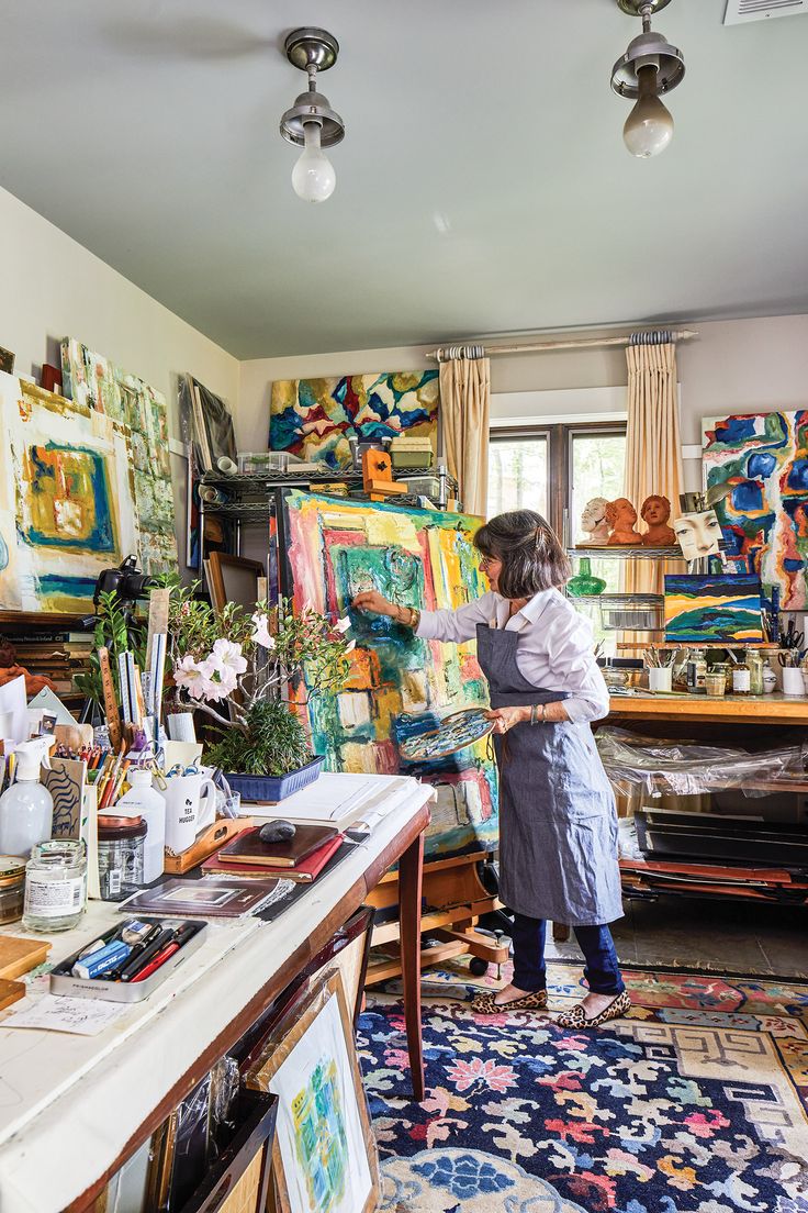 a woman is painting in an art studio