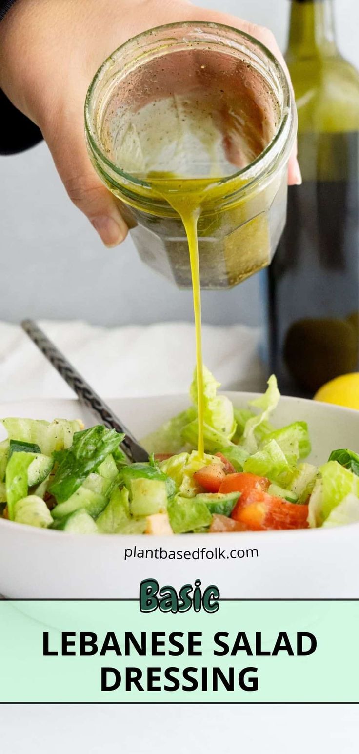 someone pouring dressing into a salad in a bowl