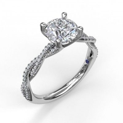 a white gold engagement ring with a twisted band and a round diamond in the center